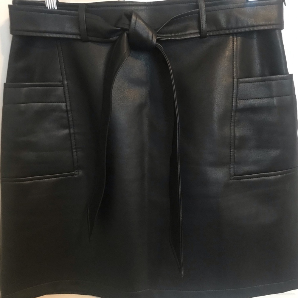 Black “leather” skirt, above the knee